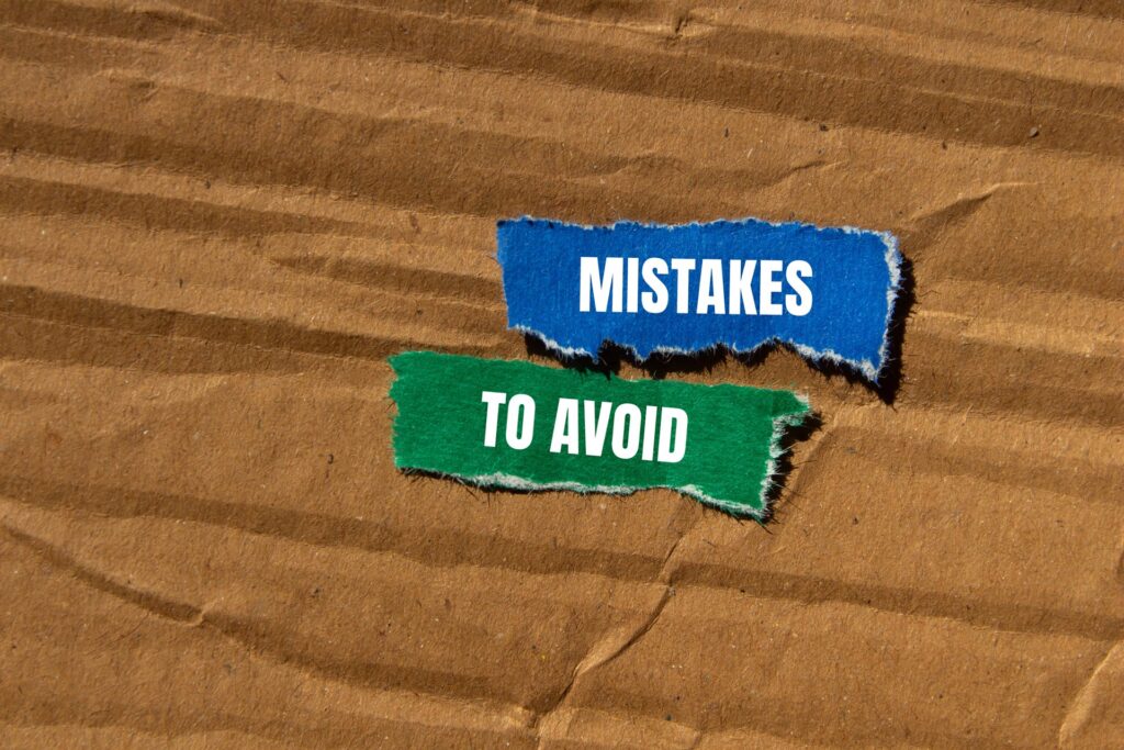 Mistakes to avoid written on ripped torn colorful paper