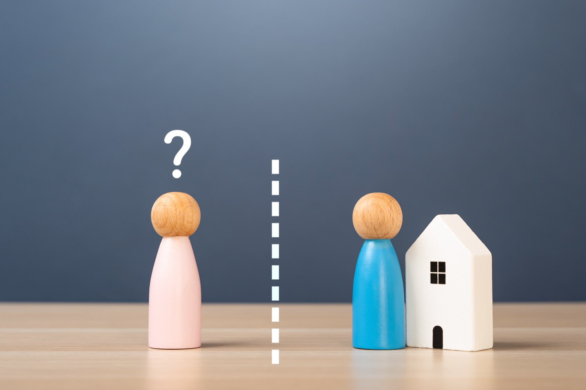 Wooden husband and wife next to a wooden house