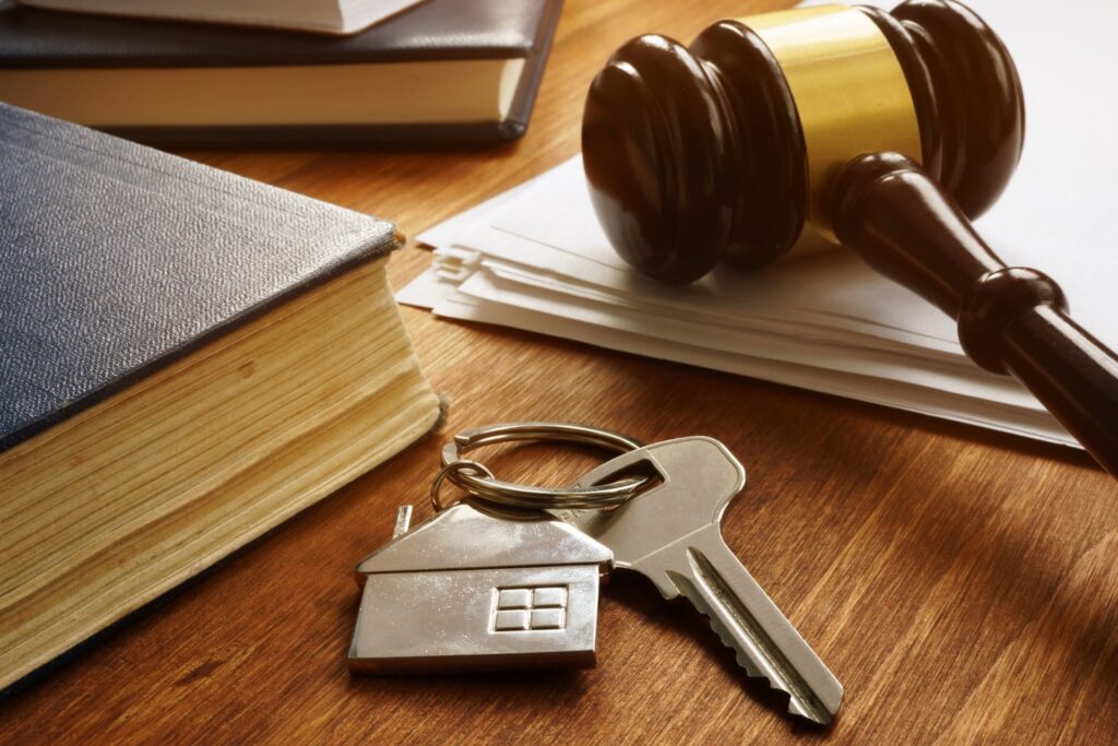 A key, gavel, book and paperwork